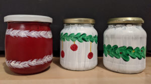 Marmeladen- oder Honiggläser werden mit weihnachtlichem Dekor bemalt, so dass man nicht hineinschauen kann. Sie sind ein Adventskalender