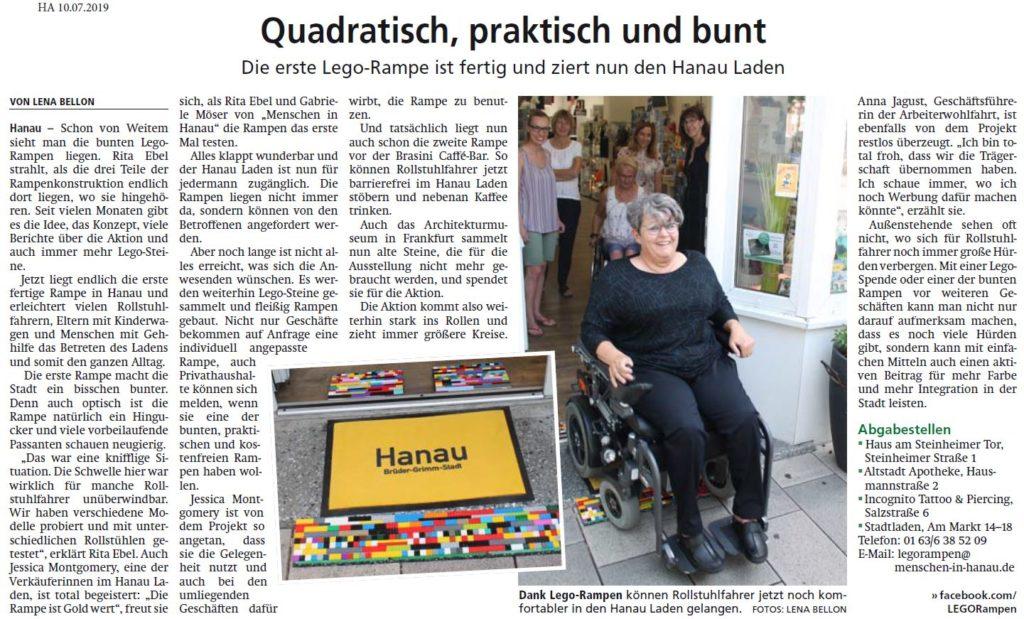 Auf dem Bild zu sehen ist eine LEGO-Rampe im Hanau Laden sowie Gaby, die mit ihrem Elektro-Rollstuhl über diese nach draußen fährt.